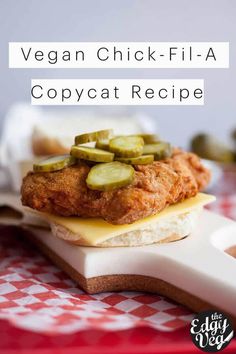 a chicken sandwich with pickles on top and the words vegan chick - fila copycat recipe