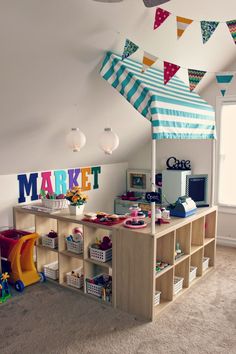 a child's playroom with toys and decorations on the walls, including bookshelves