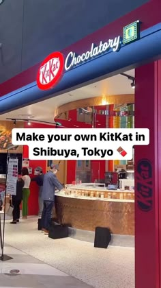 people are standing in front of a kiosk with the words make your own kitkatt in shibuya, tokyo