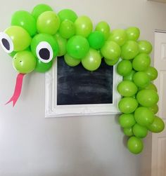 a bunch of balloons that are shaped like a caterpillar with eyes and nose