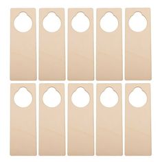 six unfinished wooden door hangers with holes in the middle and four on each side