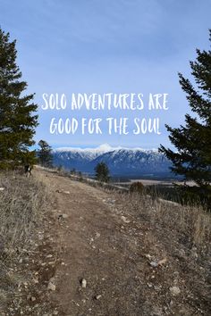 a dirt road with the words solo adventures are good for the soul