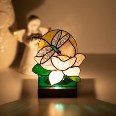 a stained glass flower sitting on top of a table