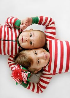 three children in striped pajamas laying on top of each other