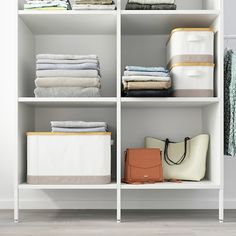 an organized closet with folded clothes and handbags on the shelve shelfs