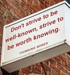 a sign on the side of a building that says don't strive to be well - known, strive to be worthing