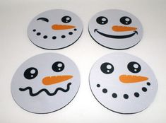 four white snowmen with orange noses and black eyes