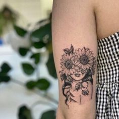 a woman with a sunflower tattoo on her arm