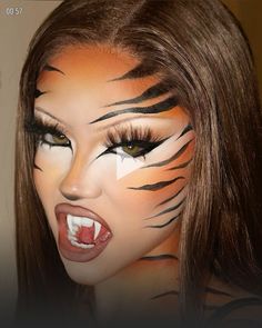 a woman with tiger stripes painted on her face and mouth is posing for the camera