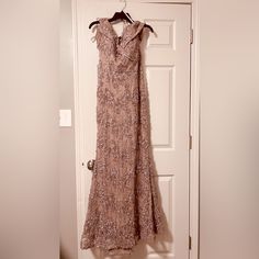 a dress hanging on a hanger in front of a door