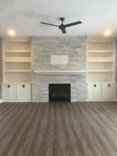 empty living room with fireplace and built in bookshelves