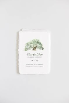 save the date card with an olive tree on it