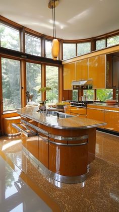 a large kitchen with an island in the middle and lots of windows on both sides