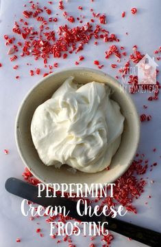 peppermint cream cheese frosting in a bowl with red sprinkles