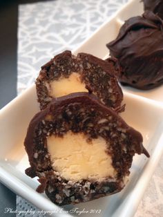 three pieces of chocolate covered dessert on a white plate