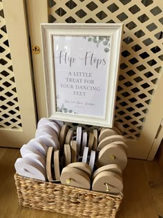 a basket filled with flip flops next to a sign