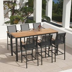 an outdoor table and chairs on a patio