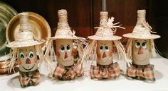 three scarecrows with hats and bows on their heads are sitting next to each other