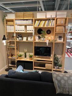 a living room filled with furniture and bookshelves on top of eachother