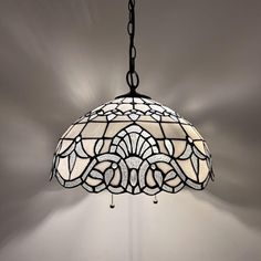 a stained glass lamp hanging from a ceiling