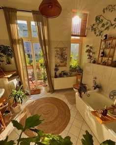 a living room filled with furniture and lots of plants next to a bathtub covered in potted plants