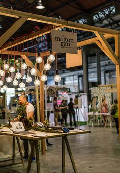 an open market with lots of lights hanging from the ceiling