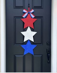 a black door with three red, white and blue stars hanging from it's side