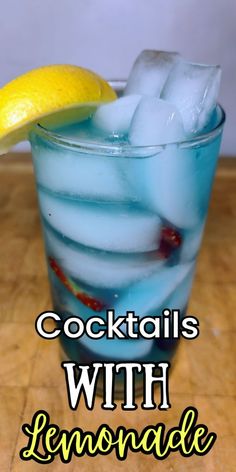 a blue drink with lemonade and ice in it on top of a wooden table