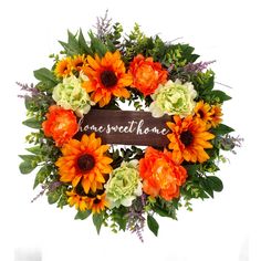 an orange and white wreath with the words home sweet home written on it