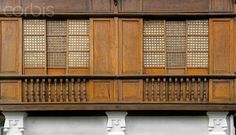 an old building with wooden balconies and windows