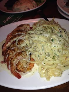 pasta with shrimp and sauce on a white plate