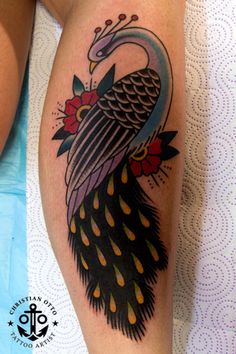 a woman with a tattoo on her arm has a peacock on it's leg