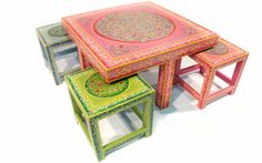 three colorful tables and stools with designs on them