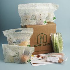 three bags of food are stacked on top of each other in front of a cardboard box