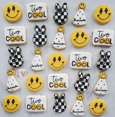 decorated cookies with smiley faces and words that say two to two are arranged on a marble surface