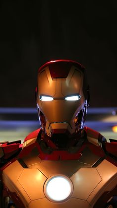 the iron man is glowing in front of a dark background with light coming from his eyes