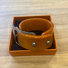 Beautiful Butterscotch Bakelite And Chrome Cuff Bracelet. Perfect Condition For A Vintage Collectible Bakelite Jewelry. Modern Cuff Bracelet Bangle As Fashion Accessory, Modern Cuff Bracelet, Adjustable Orange Cuff Bracelet, Modern Orange Bangle Bracelets, Designer Adjustable Brown Bracelet, Designer Brown Adjustable Bracelet, Elegant Adjustable Orange Bangle, Designer Adjustable Cuff Bracelet, Adjustable Designer Cuff Bracelet