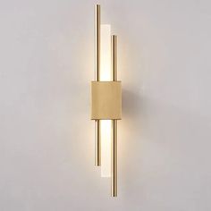 a wall light with two lights on each side and a rectangular tube in the middle