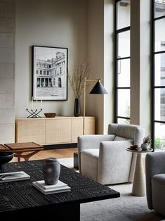 a living room filled with furniture and large windows