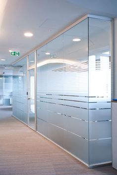 an empty office with glass walls and doors