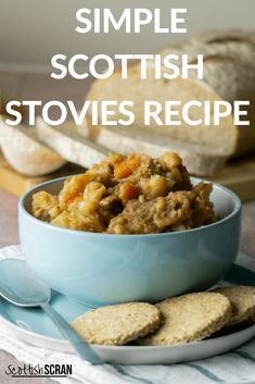 a blue bowl filled with stew next to crackers