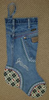 a pair of blue jeans with an applique on the bottom