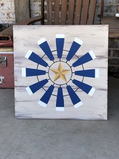 a wooden sign with an image of a star in the center and blue stripes on it