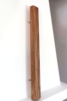 a wooden object sitting on top of a white shelf