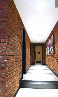 an empty hallway between two brick buildings