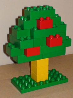 a lego christmas tree with red and yellow bricks