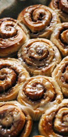 there are many cinnamon rolls on the pan together and they are ready to be eaten