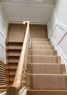 a staircase with carpeted steps leading up to the second floor