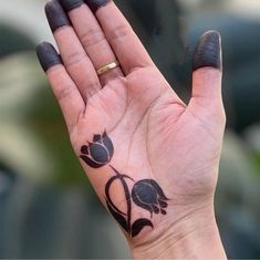 a woman's hand with a tattoo on it holding up her palm and praying