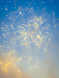 fireworks are lit up in the sky on a clear day with blue skies and clouds